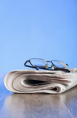 Free newspaper and glasses on the table