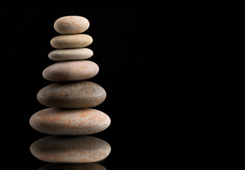 Fototapeta na wymiar balancing zen stones on black