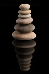 balancing zen stones on black
