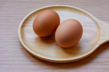 Eggs in plate on  wooden background