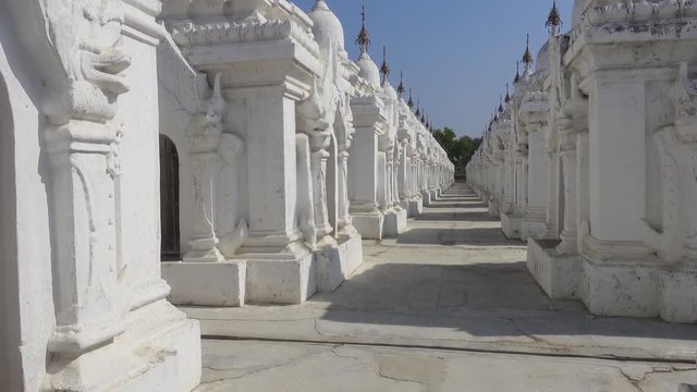 Sandamuni pagoda in Mandalay.Every of one hundreds more white pagoda in Kuthodaw temple has a page of book inside. Tracking shot 4k
