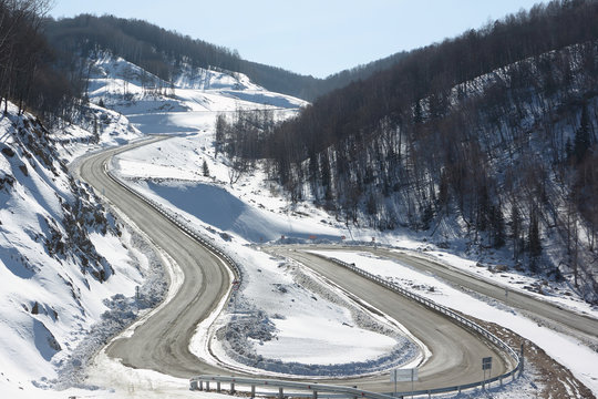 Mountain  highway among snow slope , Belokurikha,  Altai, Russia