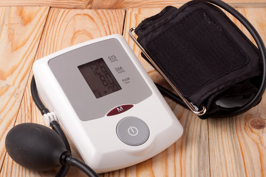 automatic blood pressure monitor on a wooden background