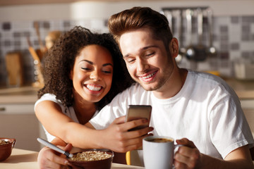 Pleasant couple sitting in the kitchen