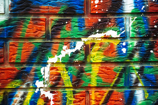 Colorful paint sprayed brick wall © Bits and Splits