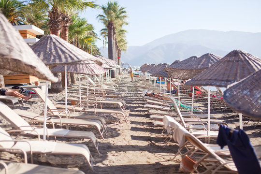 Beach with sun umbrellas and loungers. Marmaris. Turkey