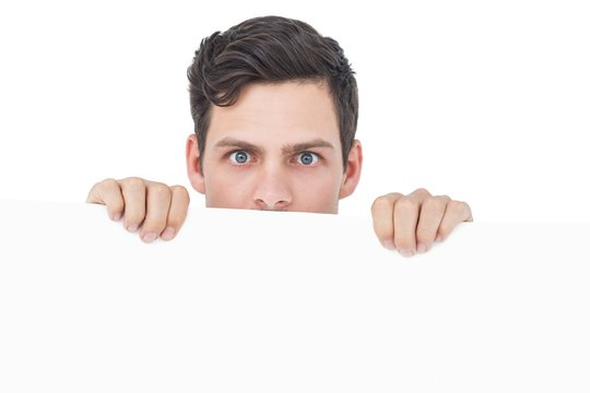 Handsome Man Holding A White Poster