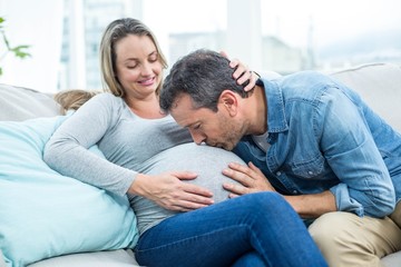 Man kissing pregnant womans stomach