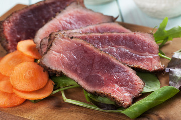 Rare beef steak with carrot and fresh salad