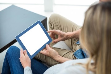 Couple using digital tablet