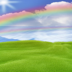 Plakat Green area by the sea with rainbow