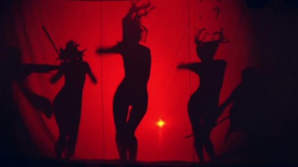 Theatrical three girls dance on a red background. Two salakutt hunt with bows on them