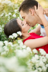 Happy young couple kissing in park