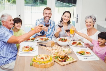 Portrait of smiling family toasting drinks 
