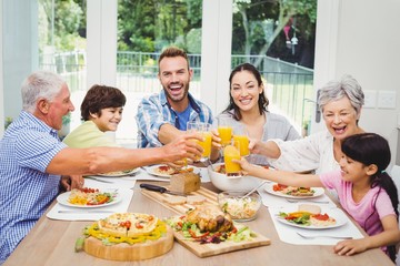 Smiling family toasting juice