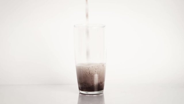 Pouring cola soda in glass