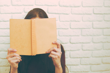 Pretty relaxed young woman reading a book