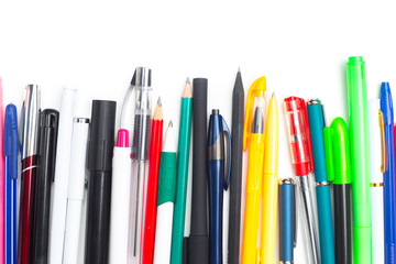 Pens and pencils on white background
