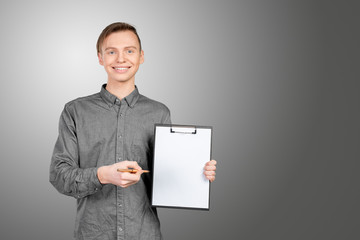 confident young man in shirt making notes in his pad