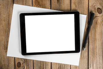 blank tablet device over a wooden workspace table