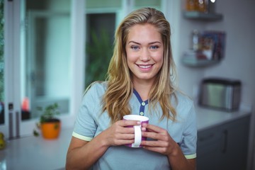 Portrait of beautiful young woman drinking coffee 