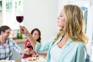 Woman holding red wine glass 