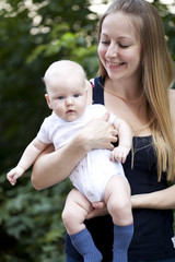 Happy mother and her little son outdoors session