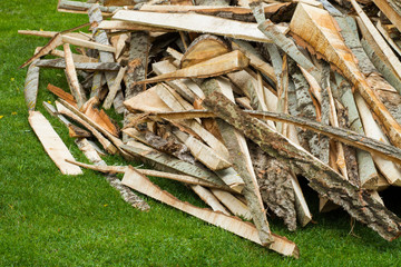 firewood pile on green grass