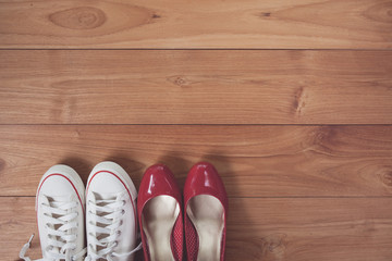 Vintage tone of couple shoes over wooden deck floor.