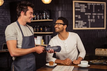 Man paying his coffee with credit card