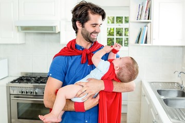 Father and son in superhero costume playing in kitchen © WavebreakmediaMicro