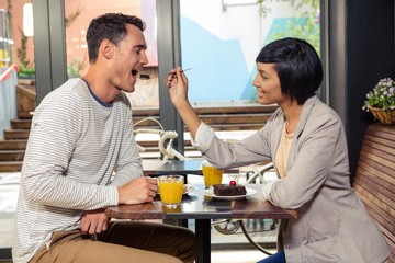 Girlfriend feeding her boyfriend