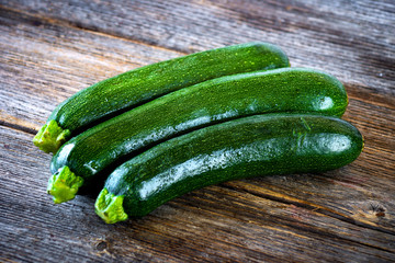 Fresh zucchini on wooden background