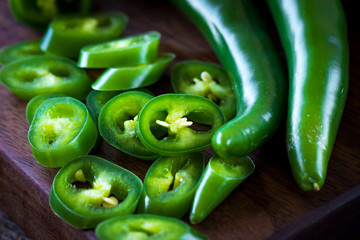 Fresh green chilli on old wooden background