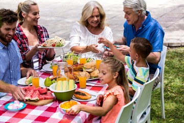 Happy family having lunch at lawn