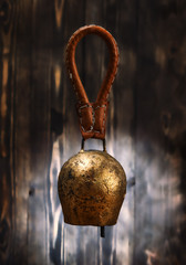 Cowbell on wooden background..