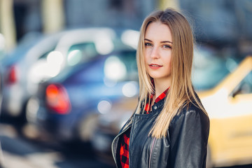 Portrait of young pretty girl standing on the street