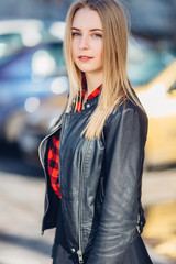 Fototapeta premium Portrait of young pretty girl standing on the street