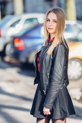 Portrait of young pretty girl standing on the street