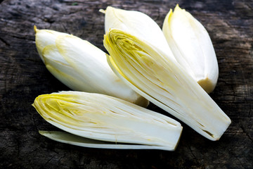 Fresh Chicory Salad  on  rustic wooden table.