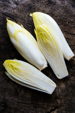 Fresh Chicory Salad  on  rustic wooden table.