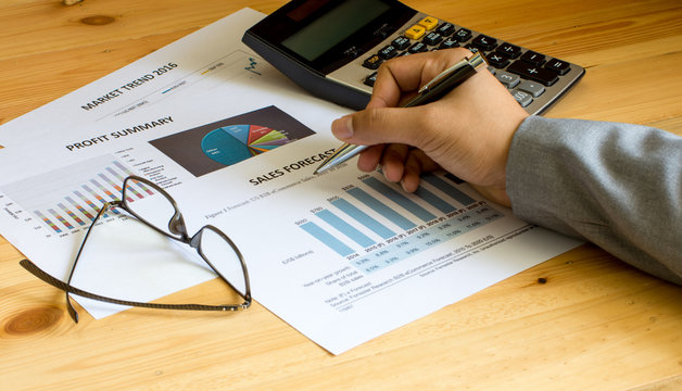 Financial accounting sales forecast graphs analysis with hand writing