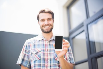 Happy man holding mobile phone