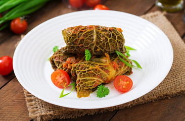 Stuffed savoy cabbage rolls in tomato sauce