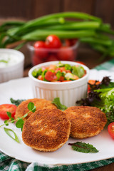 Small chicken cutlet with vegetables on a plate