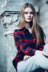 Blonde pretty girl standing in front of building