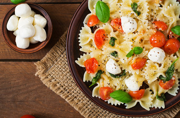 Farfalle Pasta - Caprese salad with tomato, mozzarella and basil. Top view