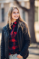 Girl standing on the street with sunset background