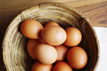 Organic raw eggs in wood basket. Eggs in basket. Hen eggs. Fresh organic eggs in basket.