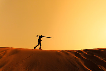 A man walking on sand desert